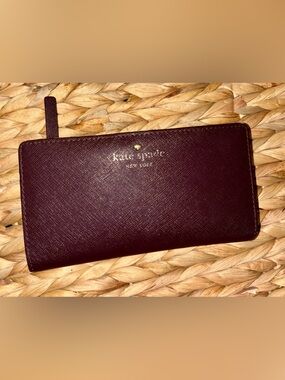 kate spade burgundy saffiano leather zip wallet with gold logo
